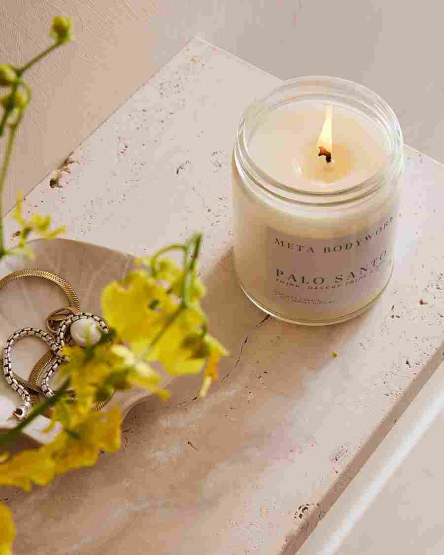 Lit Palo Santo candle creating a calming spa environment for a detox massage session
